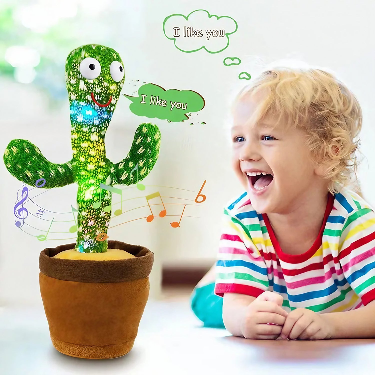 A young child engaged joyfully with a Soulful Trading Original Dancing Cactus Toy in a pot, which displays speech bubbles saying &quot;I like you&quot;.