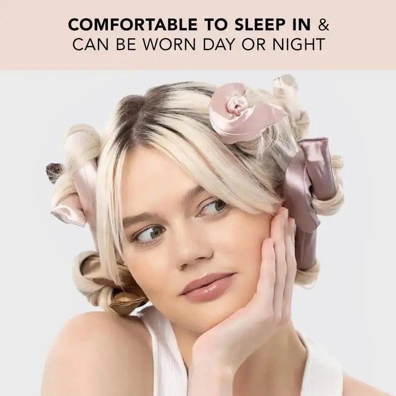 A woman with blonde hair adorned with pink satin hair rollers looks at the camera, text above her reads &quot;comfortable to sleep in &amp; can be worn day or night.