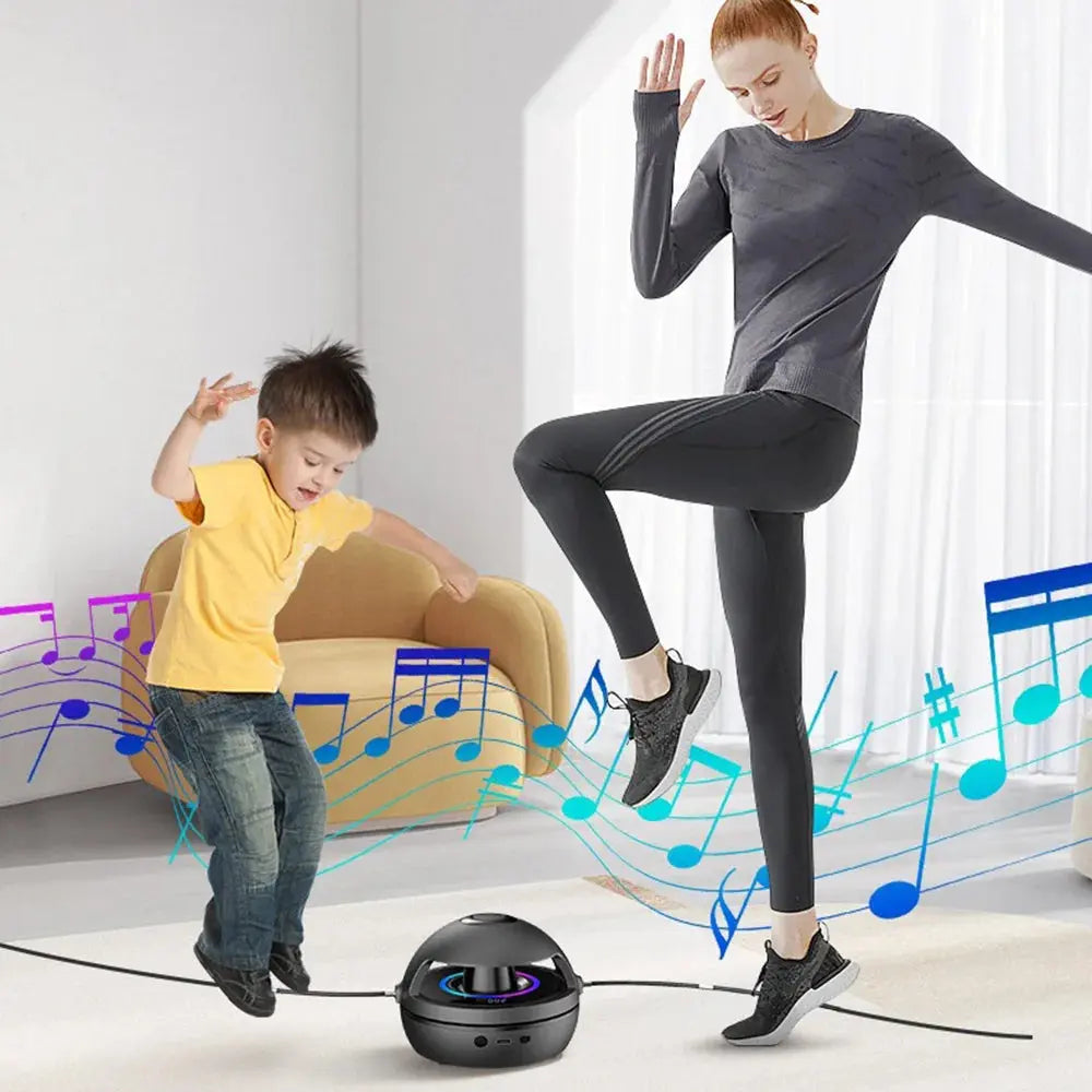 A woman and a young boy dancing joyfully in a living room, with musical notes illustrated around them, as music plays from a Soulful Trading Bluetooth-compatible speaker on the floor.