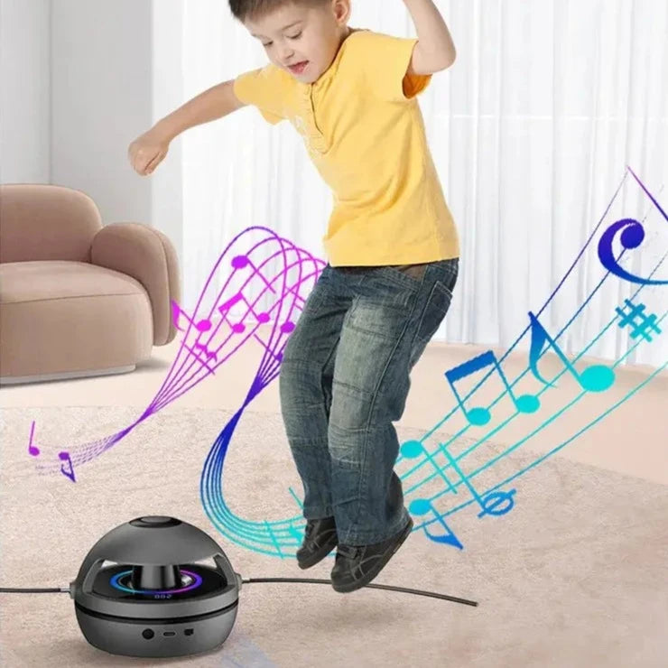 A young boy in a yellow shirt and jeans jumps energetically above a Soulful Trading Wireless Jump Rope, with colorful musical notes visually emanating from it.