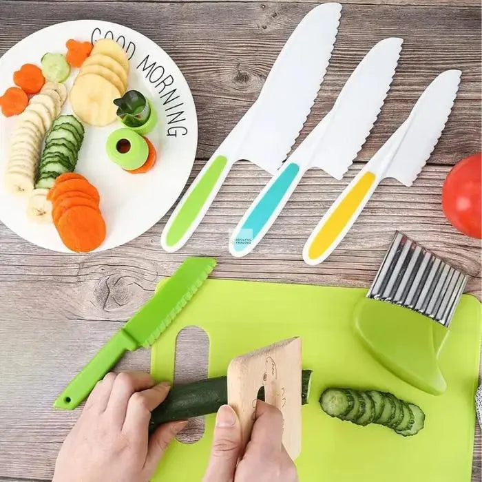 Top view of a person slicing a cucumber on a green cutting board beside a white plate of sliced vegetables and various colorful Soulful Trading Mini Chef Kid Friendly Cooking Toolset and utensils.