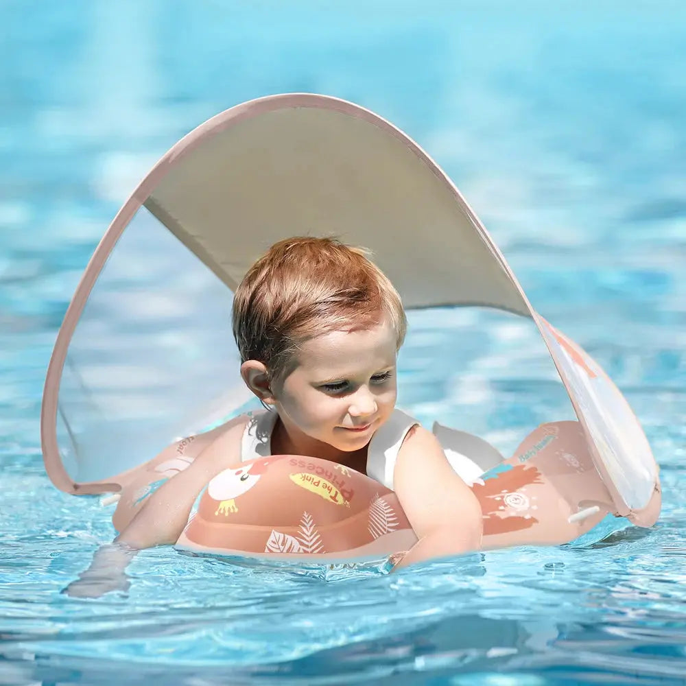 Toddler with inflatable arm bands floating in a Soulful Trading Baby Swimming Pool Float under a canopy.