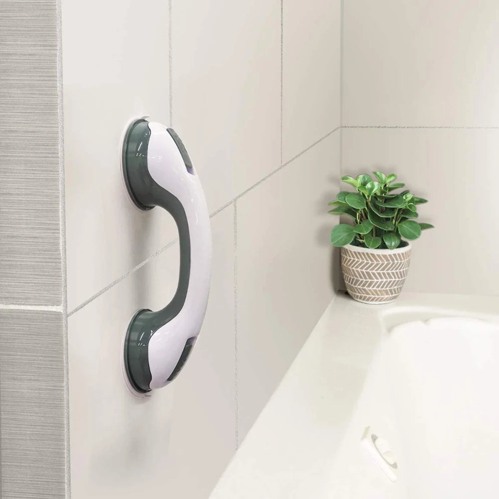 A white and gray Soulful Trading Adjustable Shower Standing Handle mounted on a tiled bathroom wall next to a small potted plant on a ledge above a bathtub.