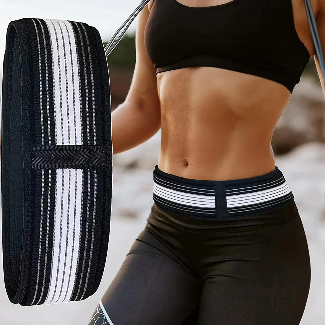 A fit woman with defined abdomen and lower back pain, wearing a black sports bra and shorts, uses a Soulful Trading Joint Hip Belt for exercise.