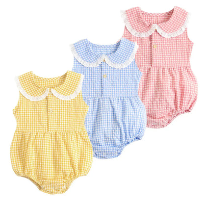 Three Spring &amp; Summer Baby Onesies in yellow, blue, and pink gingham patterns, each with ruffled collars and button details, displayed on a white background by Soulful Trading.