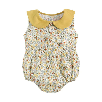 A Soulful Trading Spring &amp; Summer Baby Onesie with a yellow peter pan collar and front button details, displayed against a white background.