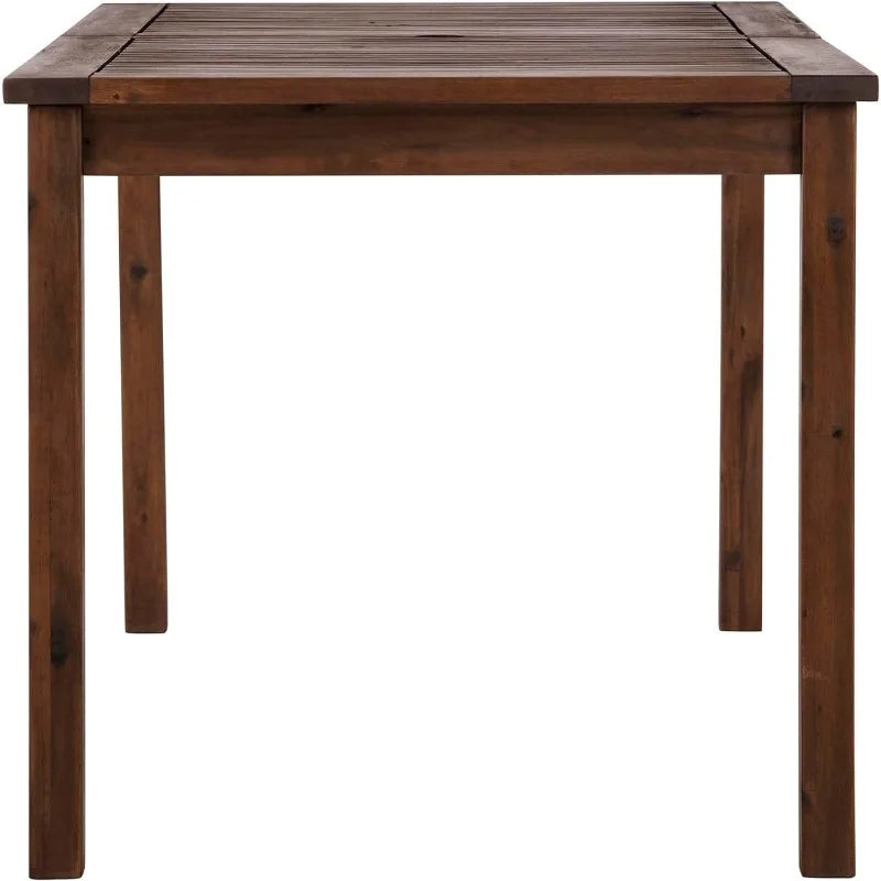 A simple Crosswinds Patio Dining Table by Walker Edison, made of acacia wood with four legs, showcasing a smooth, dark-stained finish and visible wood grain, isolated on a white background.