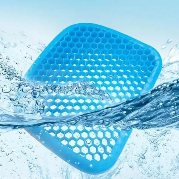 A blue hexagonal-patterned Elastic Silicone Gel Cushion from Home Essentials-5 submerged in clear, splashing water.